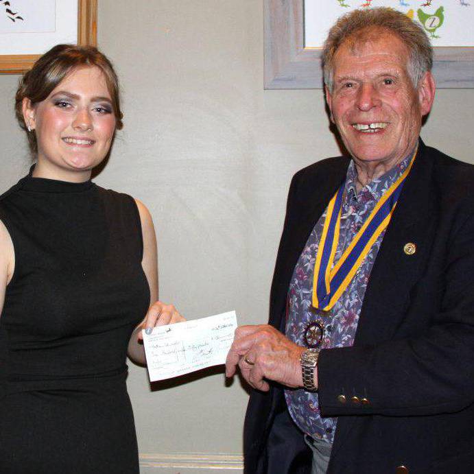 Coleg Llandrillo student Bethan Edwards receiving a cheque from Rotary Club of Rhyl president John Dicks
