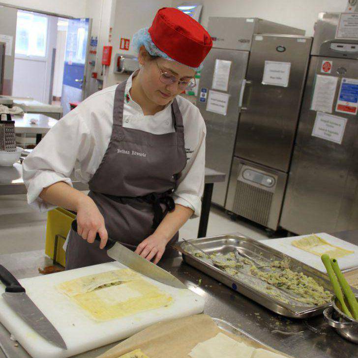 Coleg Llandrillo student Bethan Edwards preparing food in the Orme View Restaurant kitchen at the Rhos-on-Sea campus