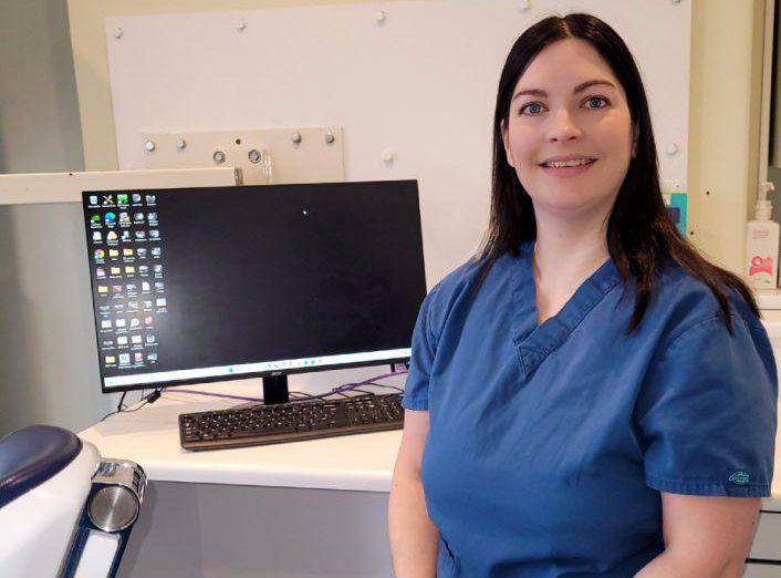 Dental nurse Carys Lloyd in her workplace, Belmont House Dental Practice in Colwyn Bay