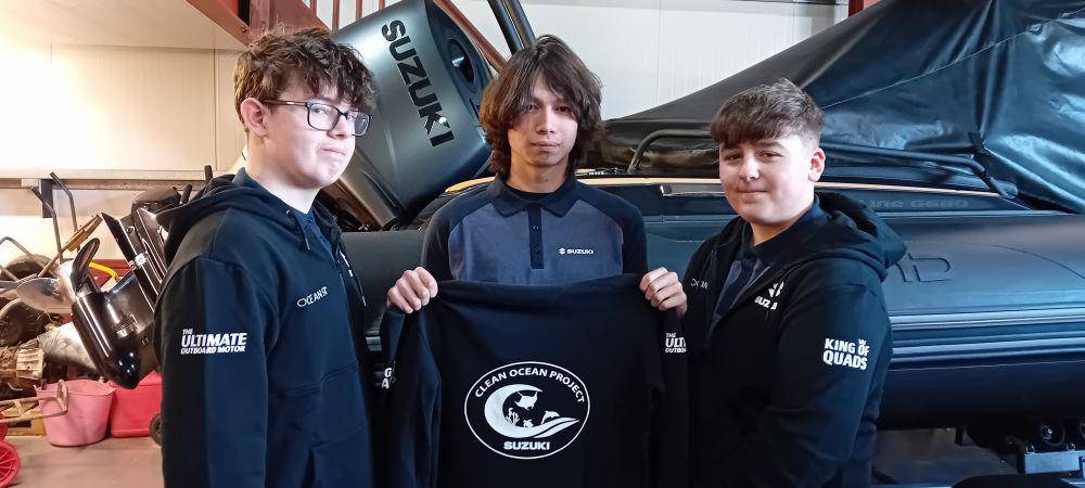 Coleg Meirion-Dwyfor students Tom, Ben and Osian showing the hoodies provided by their sponsor Suzuki Marine and Harbour Marine Services