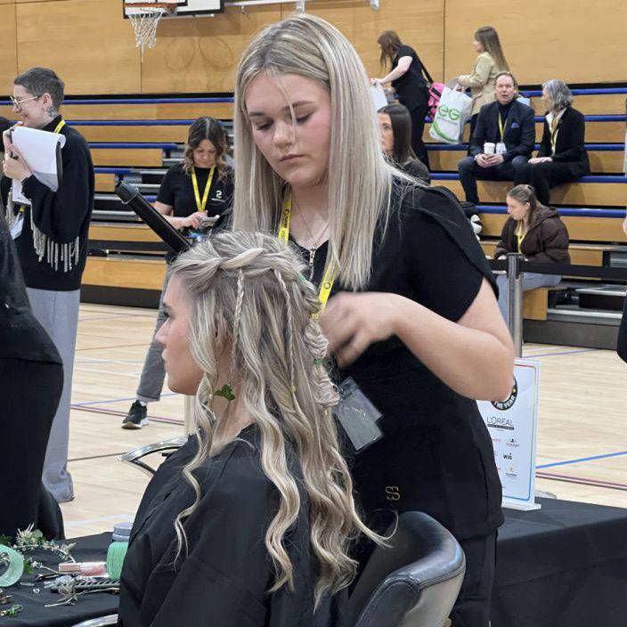 Coleg Menai student Brooke Williams styling her model’s hair during the Concept Hair Learner of the Year UK final