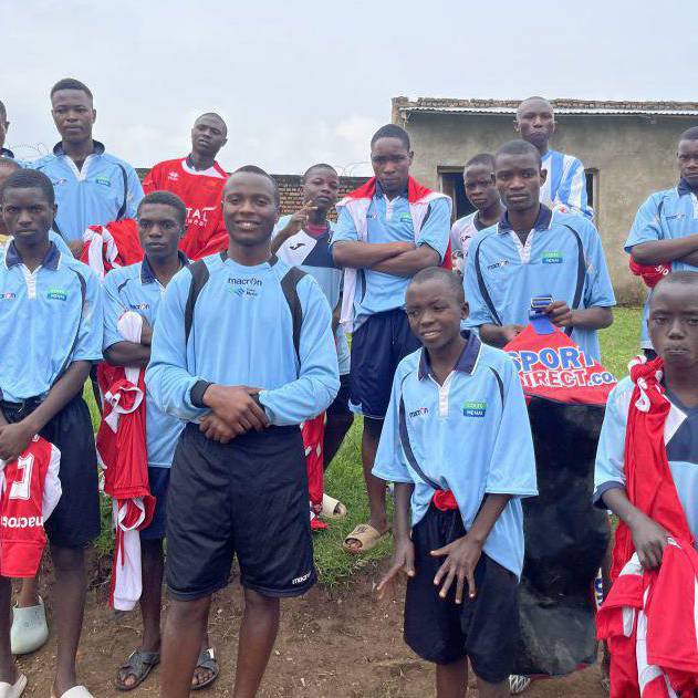 Boys in Burundi wearing Coleg Menai football kits