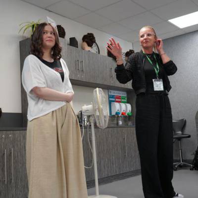 Emma Holmes, L'Oréal education consultant, presenting alongside a model styled by Coleg Meirion-Dwyfor hair and beauty students