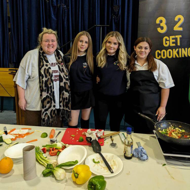 Students taking part in an interactive cooking challenge, The School Food Showdown: Restaurant Rivals, at Ysgol John Bright