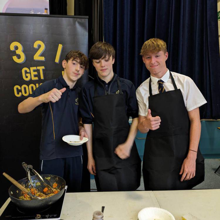 Students taking part in an interactive cooking challenge, The School Food Showdown: Restaurant Rivals, at Ysgol John Bright