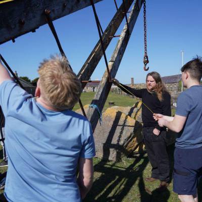 Students and workshop supervisor Phil Masterson taking measurements of one of the cranes at Caer Belan
