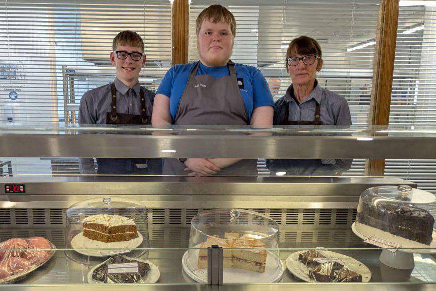 Students and staff manning a cake sale in the Bistro at Coleg Llandrillo’s Rhos-on-Sea campus