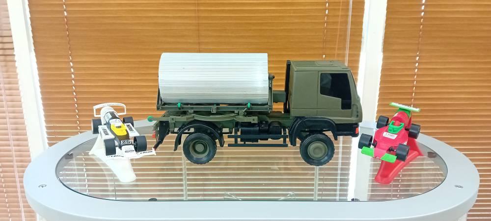 F1 in Schools race cars alongside a model of FAUN Trackway’s medium ground mobility system mounted to a 4x4