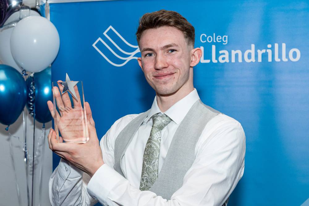 Coleg Llandrillo student Isaac Williams with his trophy at the 2024/25 Achievers’ Awards ceremony