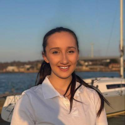 Recent Coleg Llandrillo student Erin Price with a yacht in the background