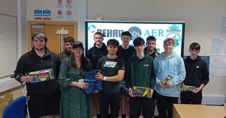 Coleg Meirion-Dwyfor engineering students being presented with toolkits from CK Tools by assistant principal Fflur Rees Jones