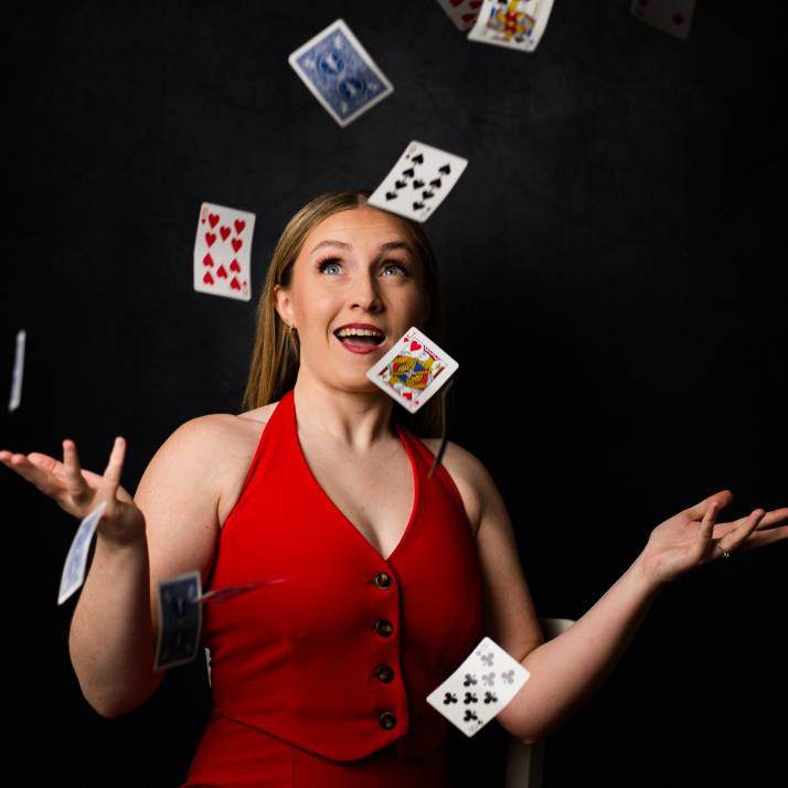 A promotional picture of Kazia Cannon throwing playing cards into the air