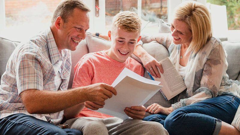 Parents and child reading a book