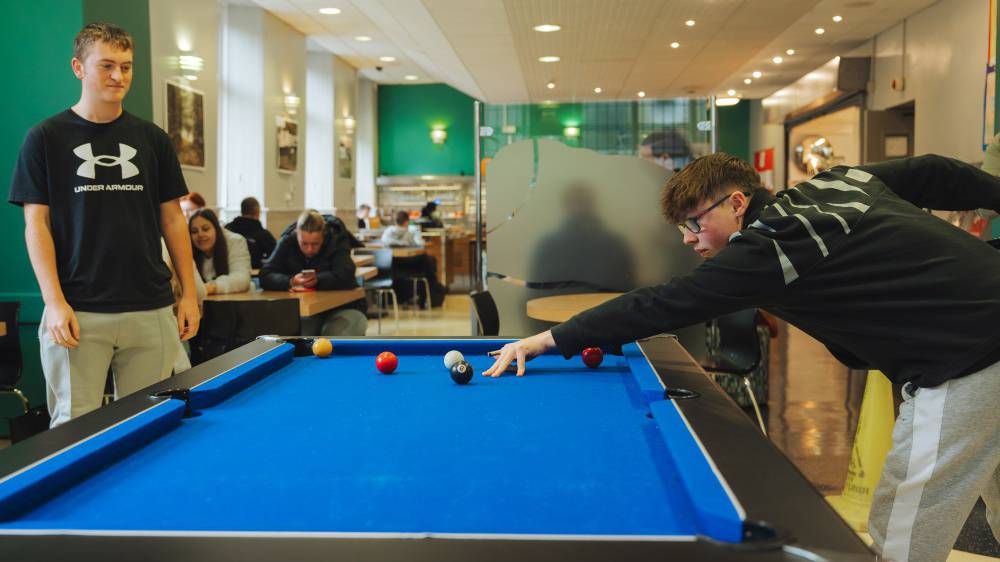Sixth form student playing pool