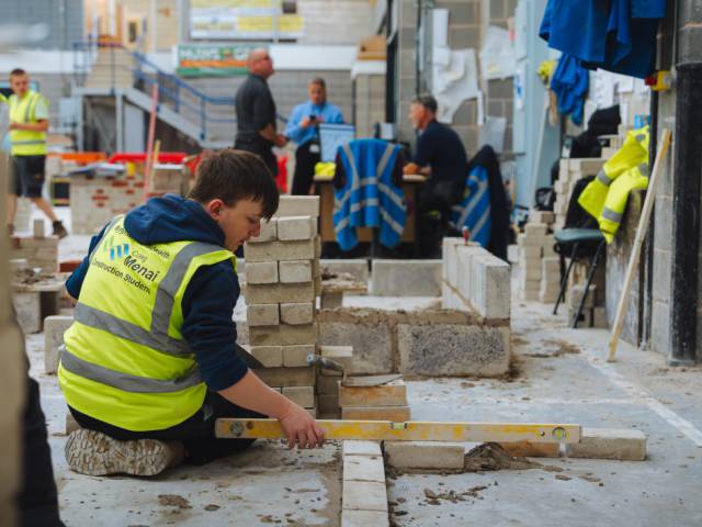 Learner ensuring brick wall is level