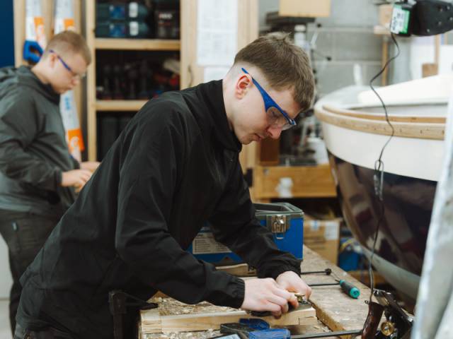 Marine Technology learner working on a boat