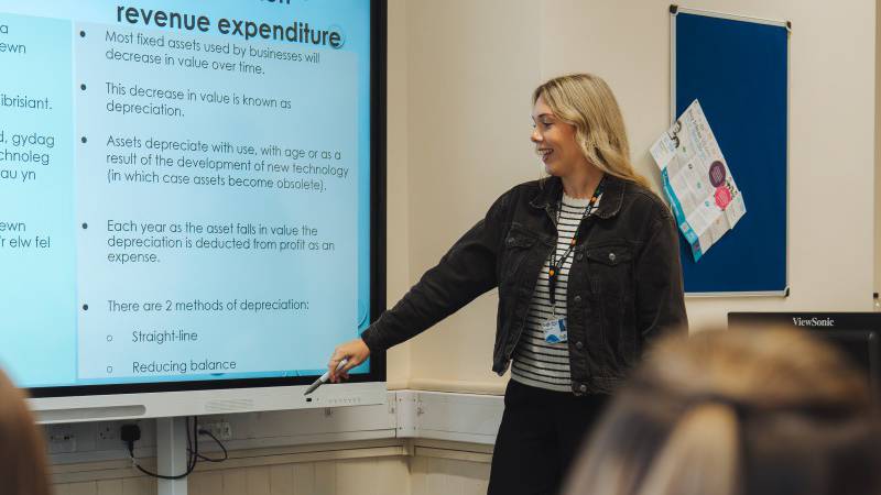 Learners being supported by a member of staff