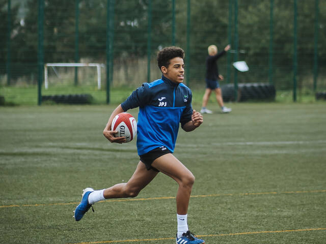 Student playing rugby