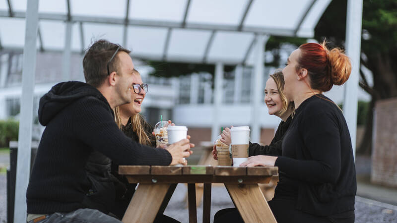 Students drinking coffee at a table