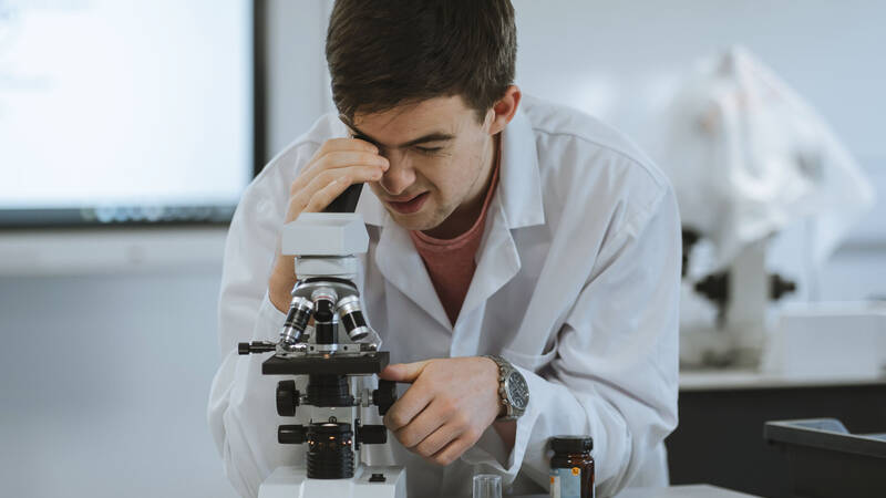 Pwllheli A-Level student using a microscope